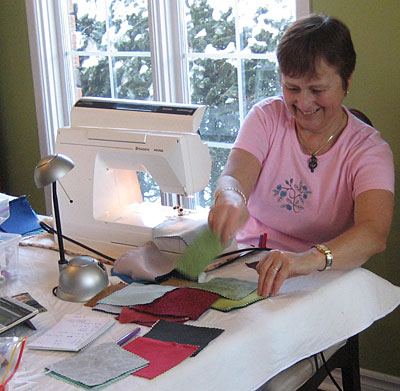 Frances sewing nine patch blocks.
