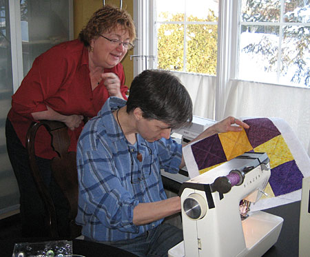 Lois and Sinead quilting the nine patch.