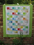 Disappearing four patch baby quilt